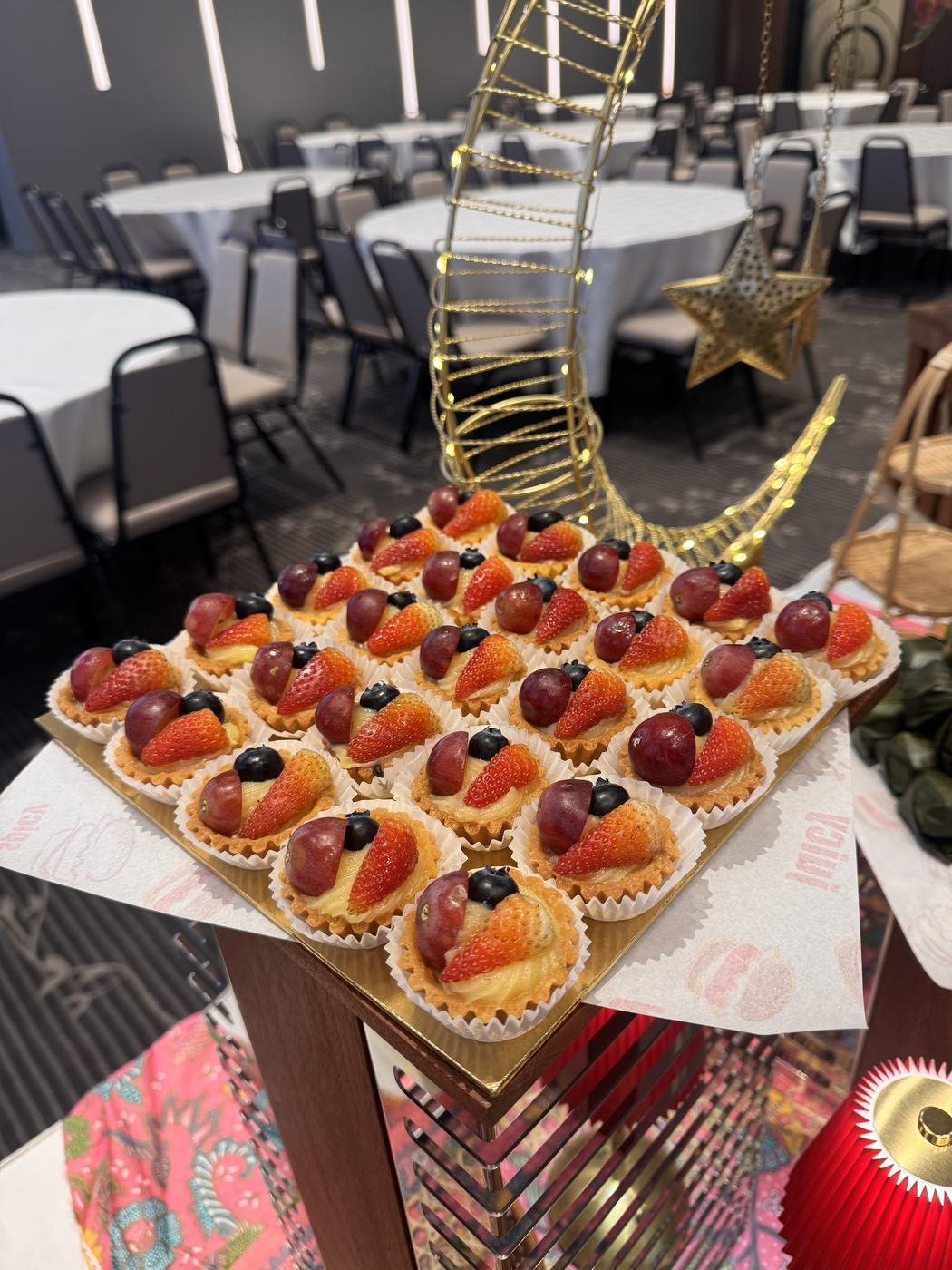 Tart buah strawberi dan anggur tersusun di dessert counter